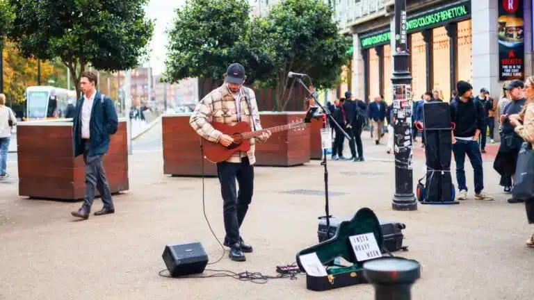 Street performer playing guitar in Dublin, Ireland. "Insta @Davy Moon" on guitar case. 2 Days in Dublin.