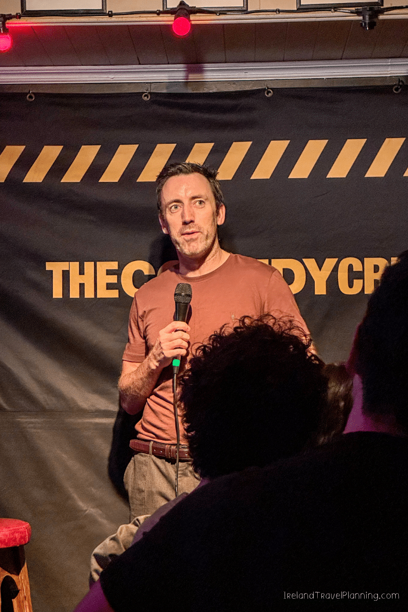 Comedian performs at The Comedy Cellar, a free thing to do in Dublin.