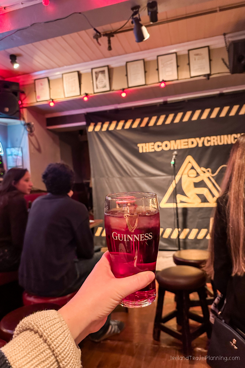 Guinness in hand at a comedy club in Dublin, a free thing to do.