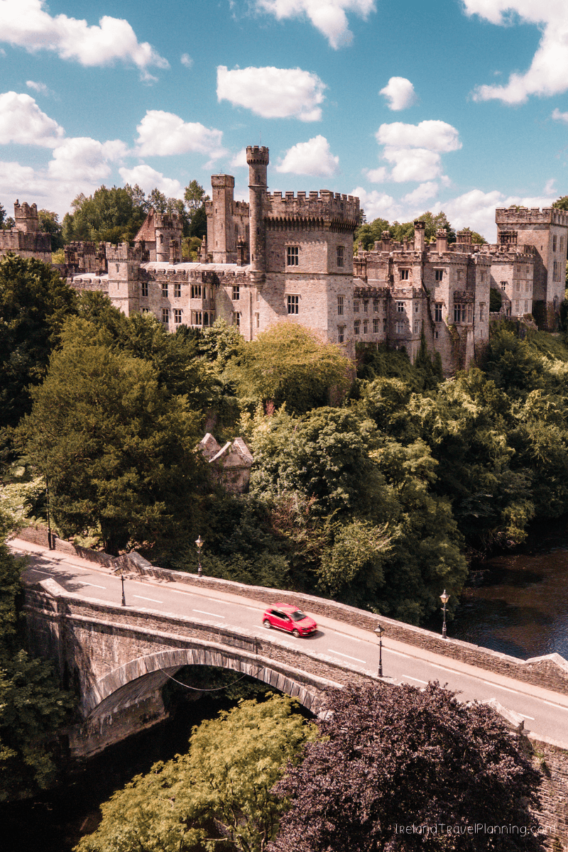 Castle in Ireland with red car crossing bridge, Ireland travel tip