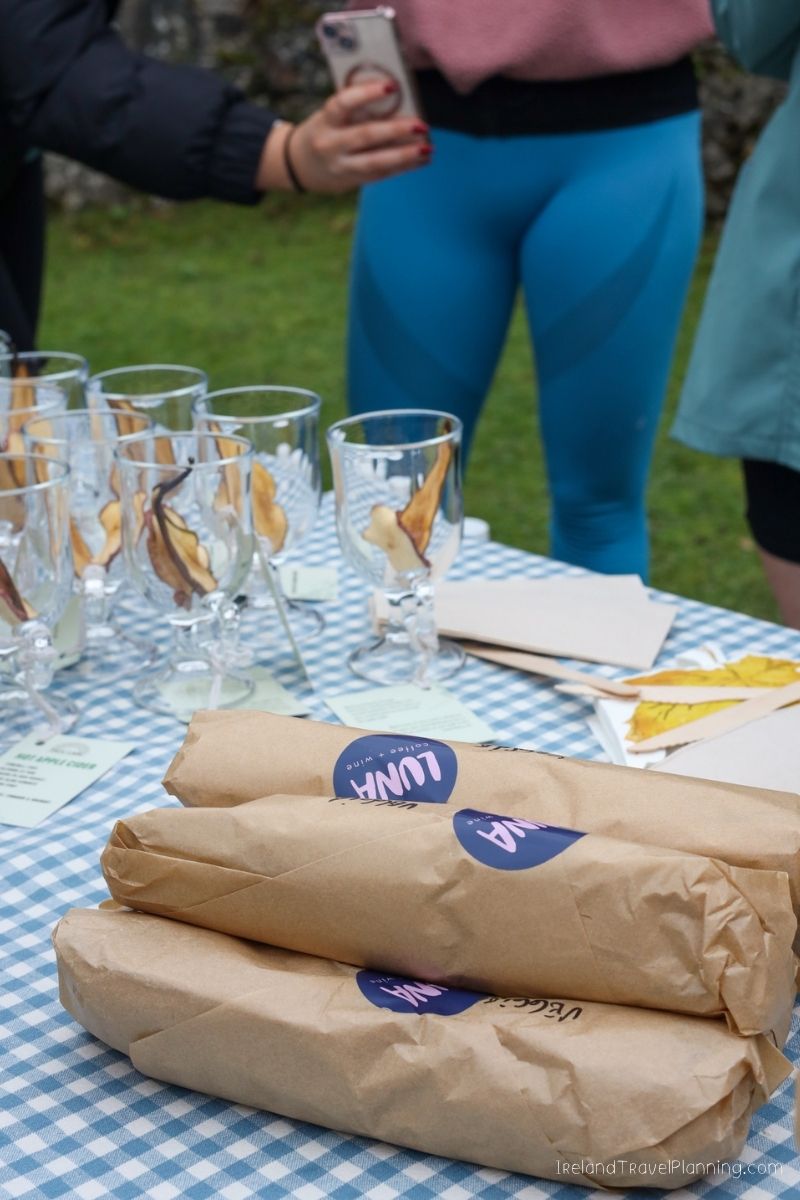 Luna cider and wine bottles on a table with tasting glasses