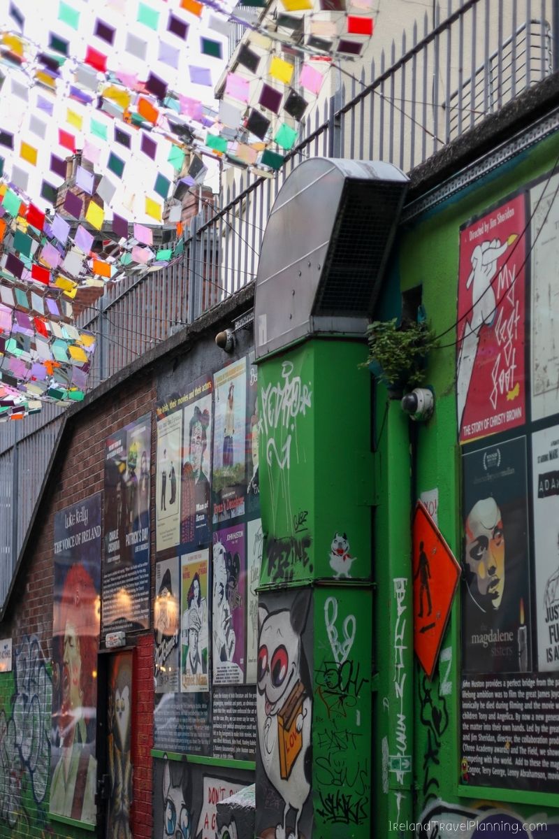 Vibrant Dublin street art and posters with colorful flags overhead, a free Dublin attraction.
