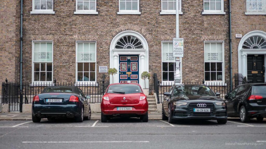Georgian architecture on Merrion Square, Dublin. "Avison Young" signs in windows. Free things to do in Dublin.