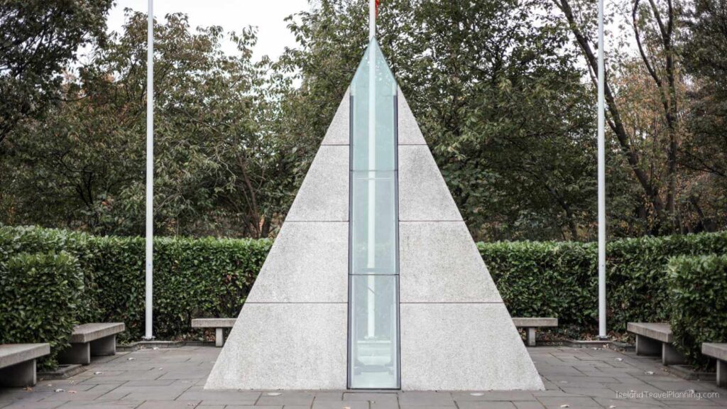 Triangular monument in Dublin park, with benches. Part of free things to do in Dublin.