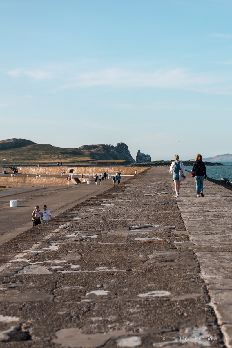 People walking on a concrete pier in Dublin, a free activity.