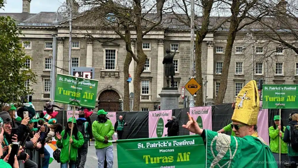 St. Patrick's Festival parade in Dublin with "Turas Alf" sign. Free things to do in Dublin.