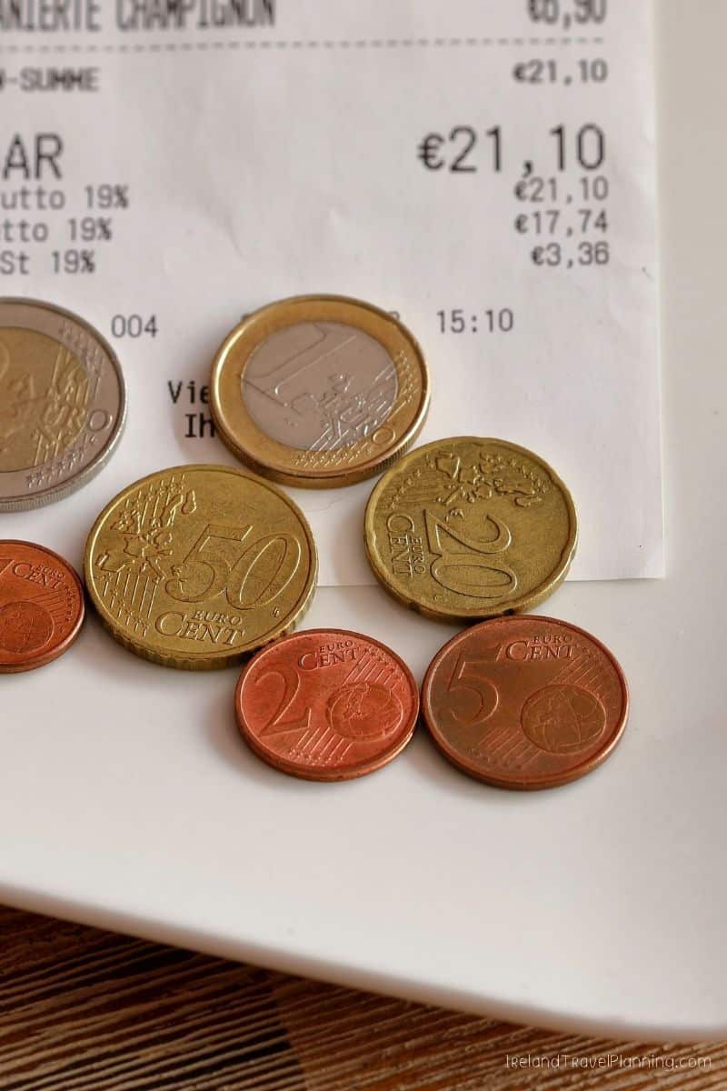 Euro coins and receipt showing prices, relevant to Ireland travel tips.