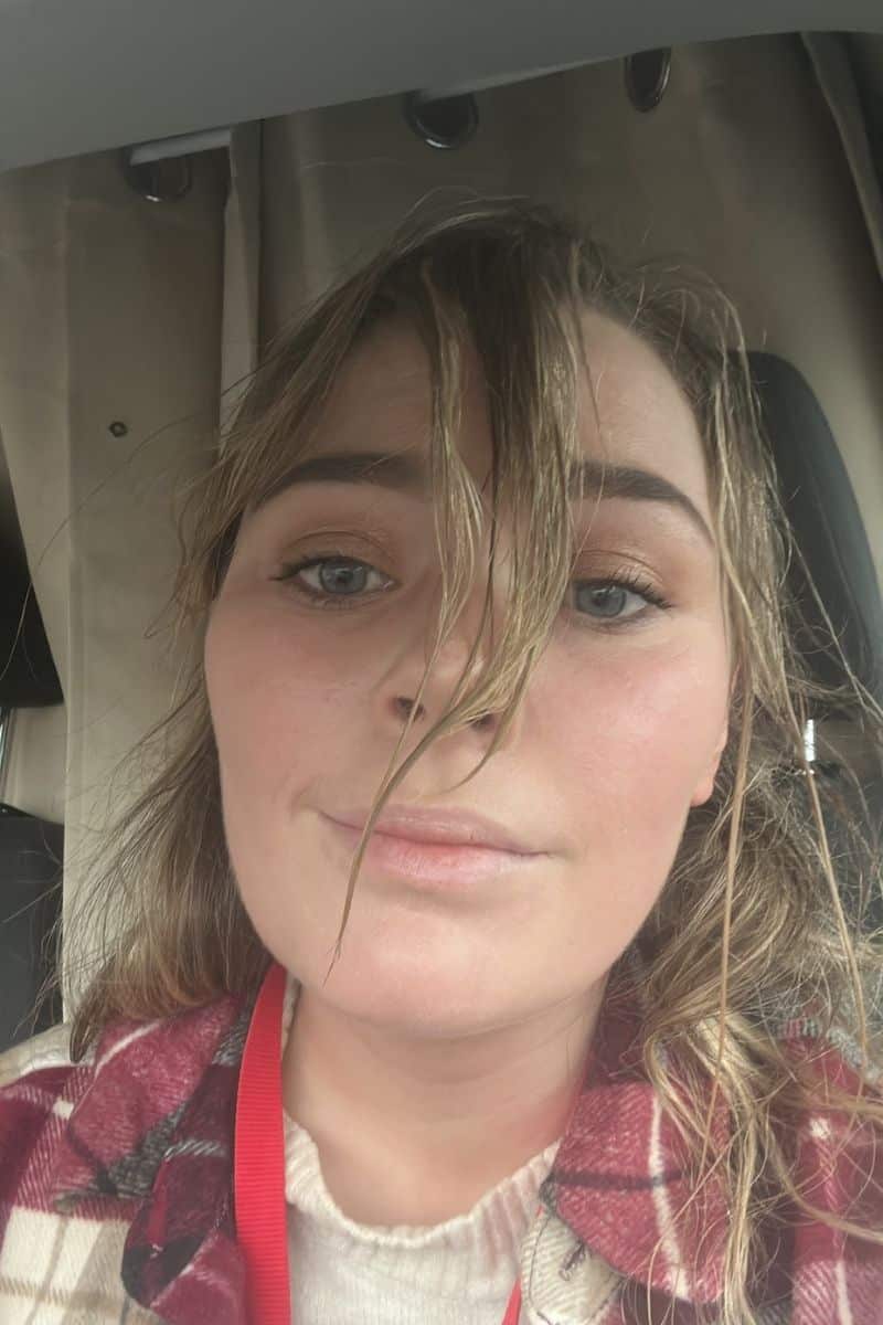 Woman with wind-blown hair in Ireland, offering travel tips