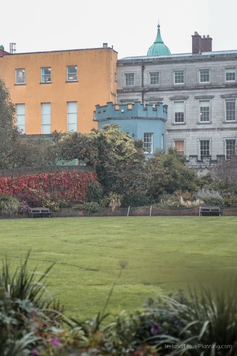 Colorful buildings overlook a green park in Dublin, Ireland travel tip.