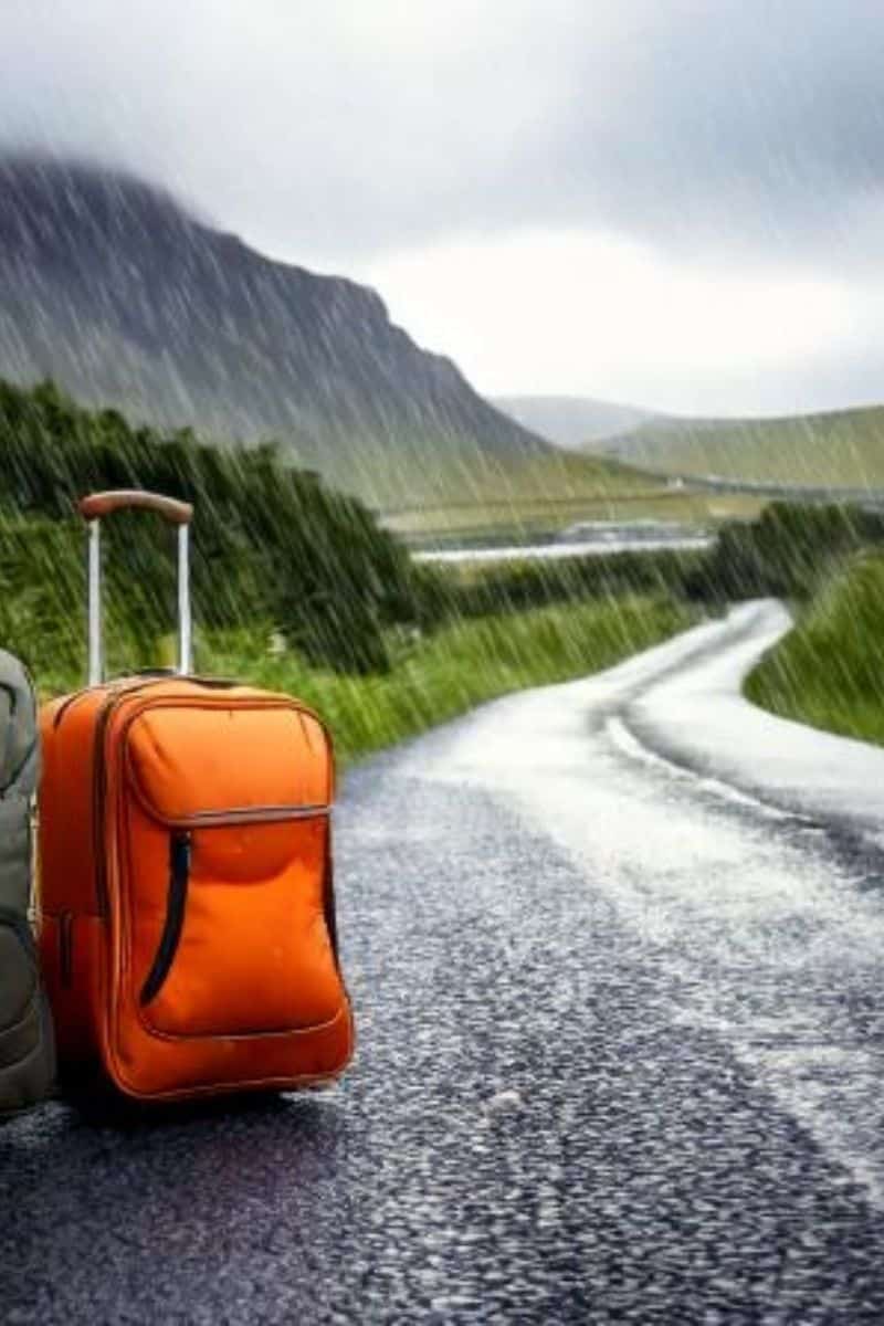 Orange suitcase on wet road in Ireland during rain, travel tips