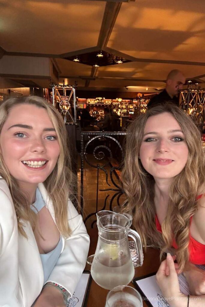 Two women smiling at a restaurant in Inis Mór, Aran Islands.
