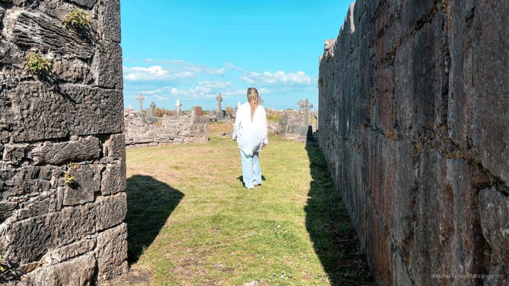 Woman walking through the ruins on Inis Mór, Aran Islands.