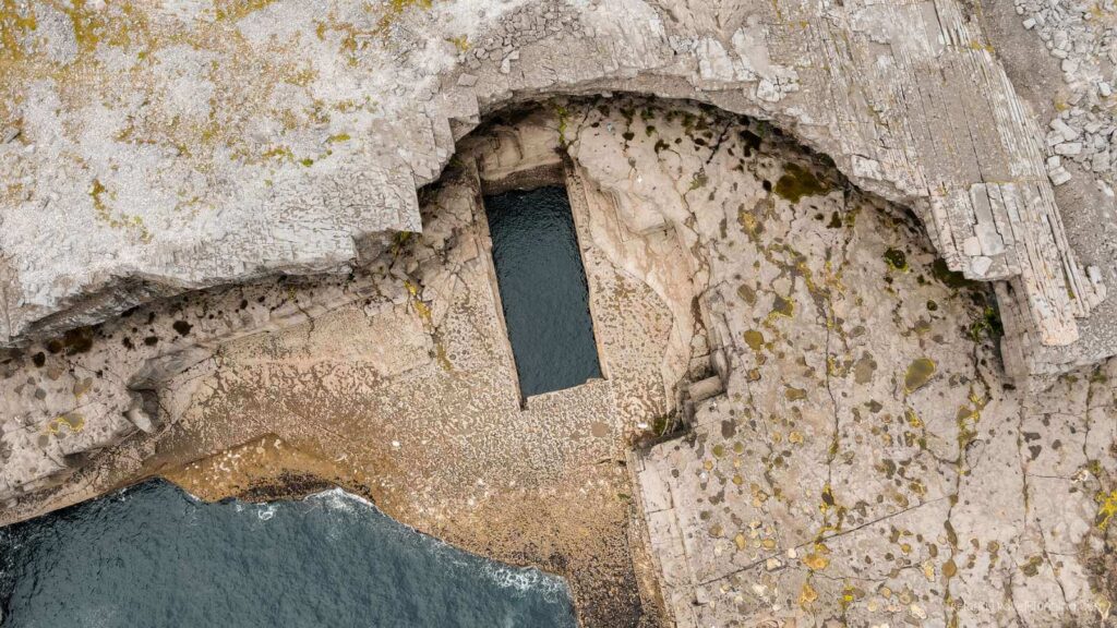 Poll na bPéist (The Wormhole) on Inis Mór, a unique natural swimming pool carved into the island's rocky coast.