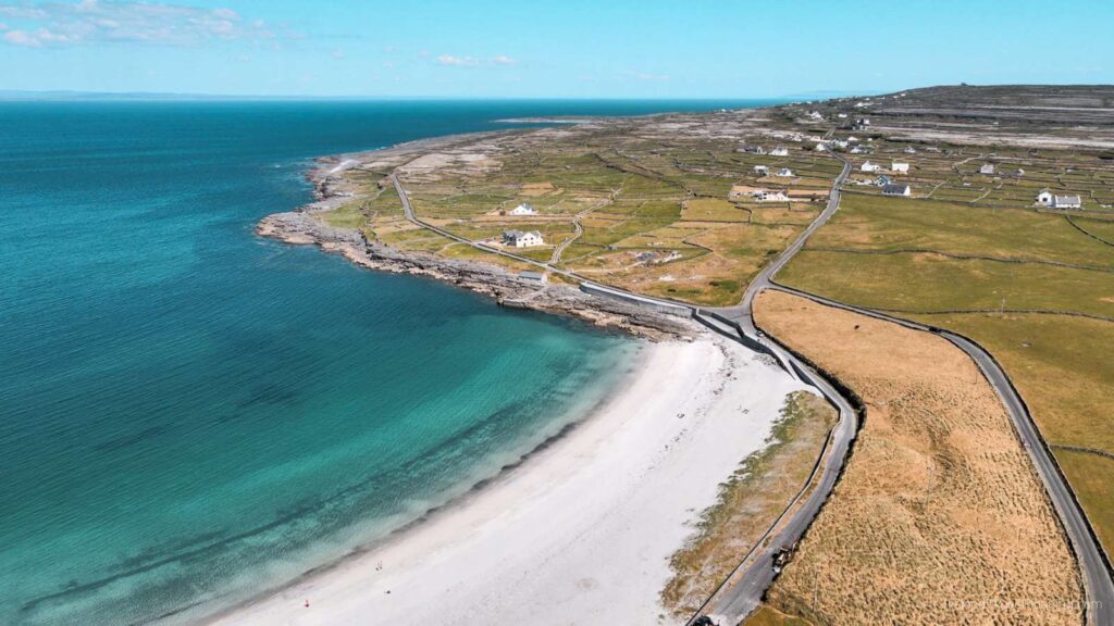 Aerial view of Kilmurvey Beach on Inis Mór, Aran Islands, with turquoise water and white sand.