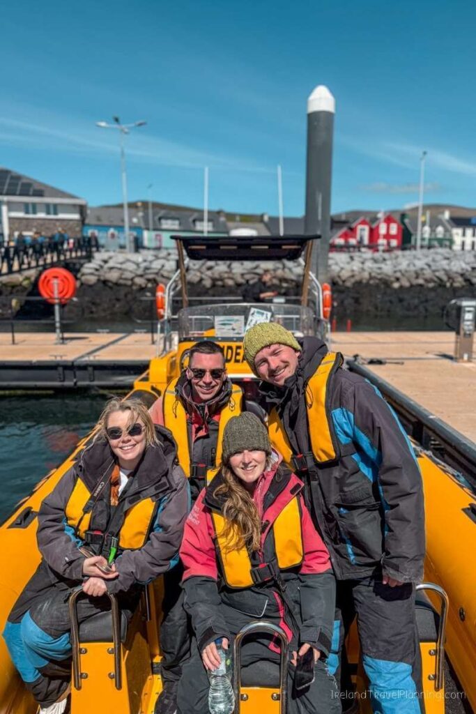 Group of tourists on a boat tour, enjoying things to do in Kerry, Ireland.