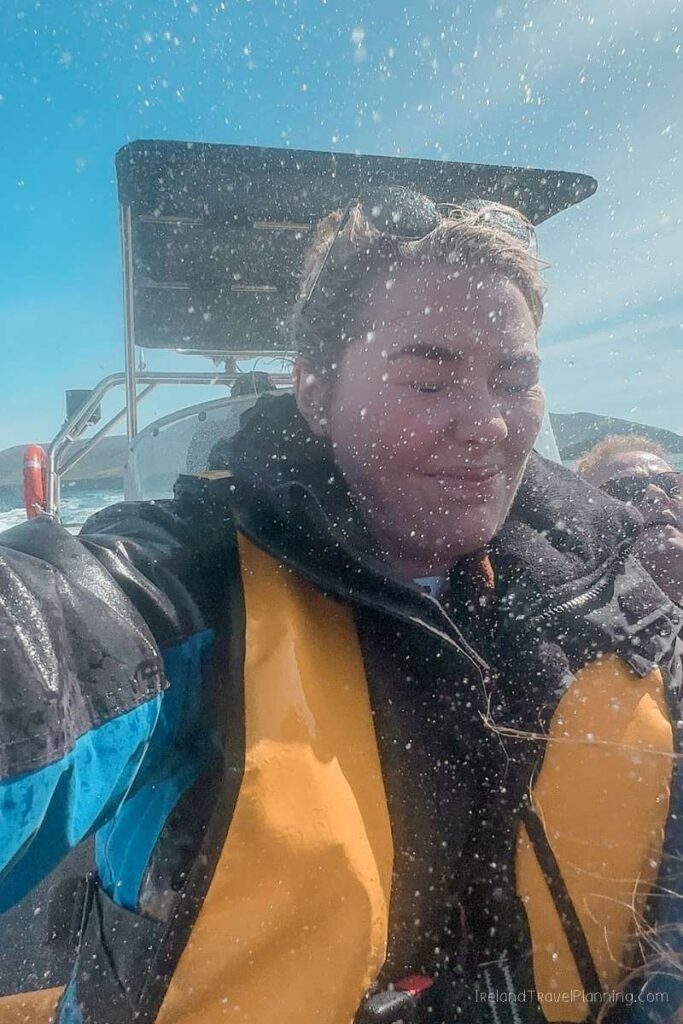 Woman on a boat tour in Kerry, getting splashed.