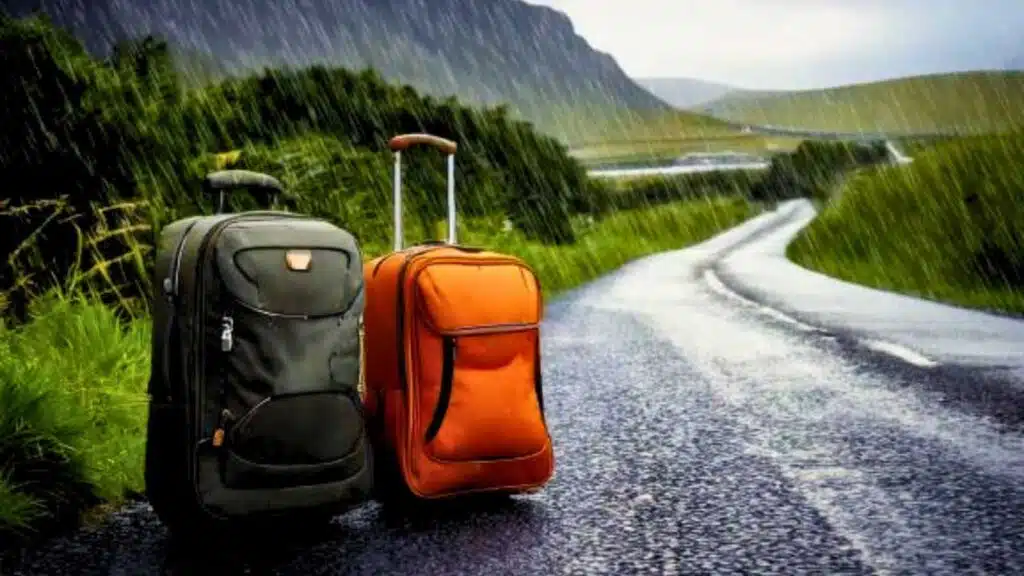 Suitcases on a rainy road in Ireland. Planning what to pack for Ireland?