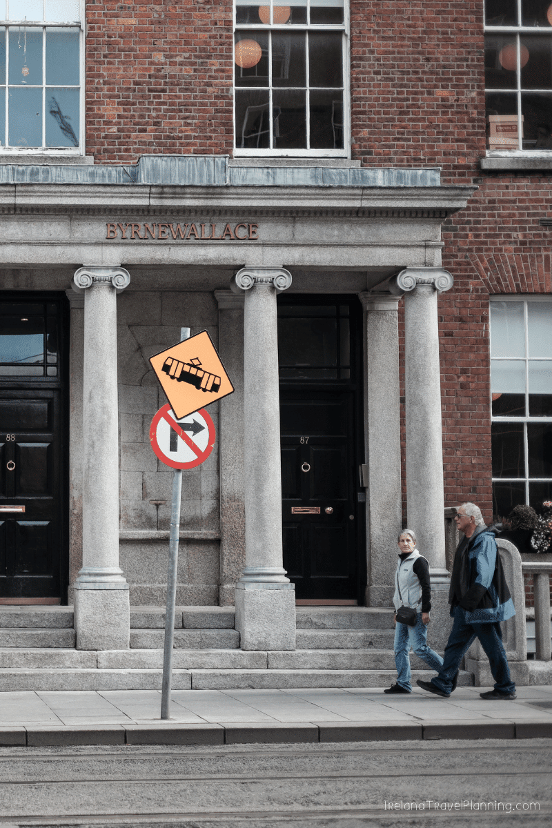Byrne Wallace building entrance with people walking, Dublin public transport