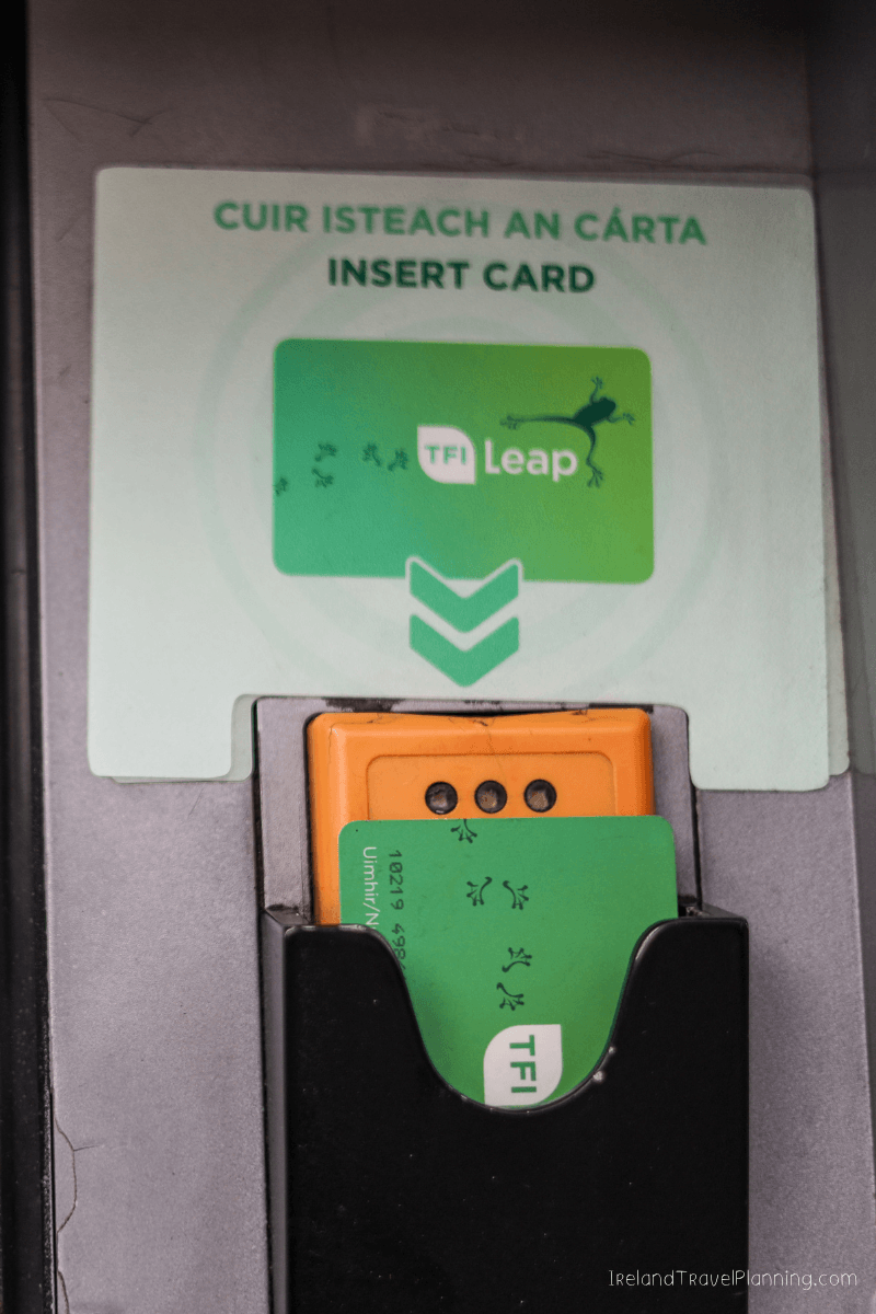 TFI Leap Card being inserted into a public transport ticket machine in Dublin.
