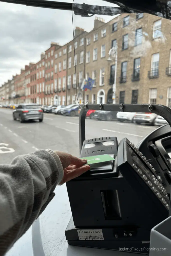 Using a Leap Card on Dublin public transport, with city street in background.
