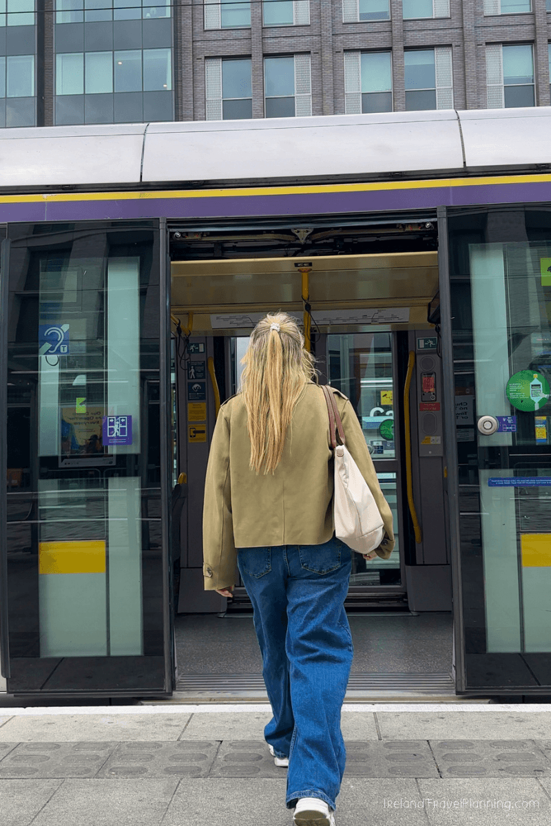 Woman boarding public transport in Dublin, Ireland.