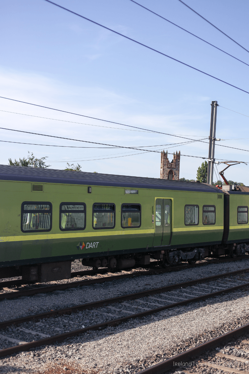 Green DART train in Dublin, Ireland, part of public transport options.
