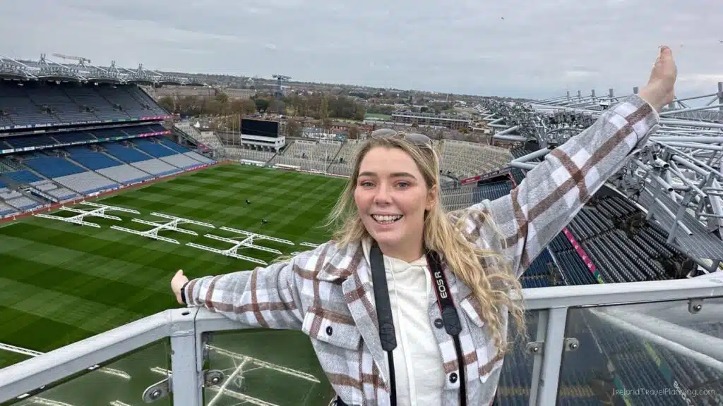 Woman at Croke Park stadium, a hidden gem in Dublin, with a camera.