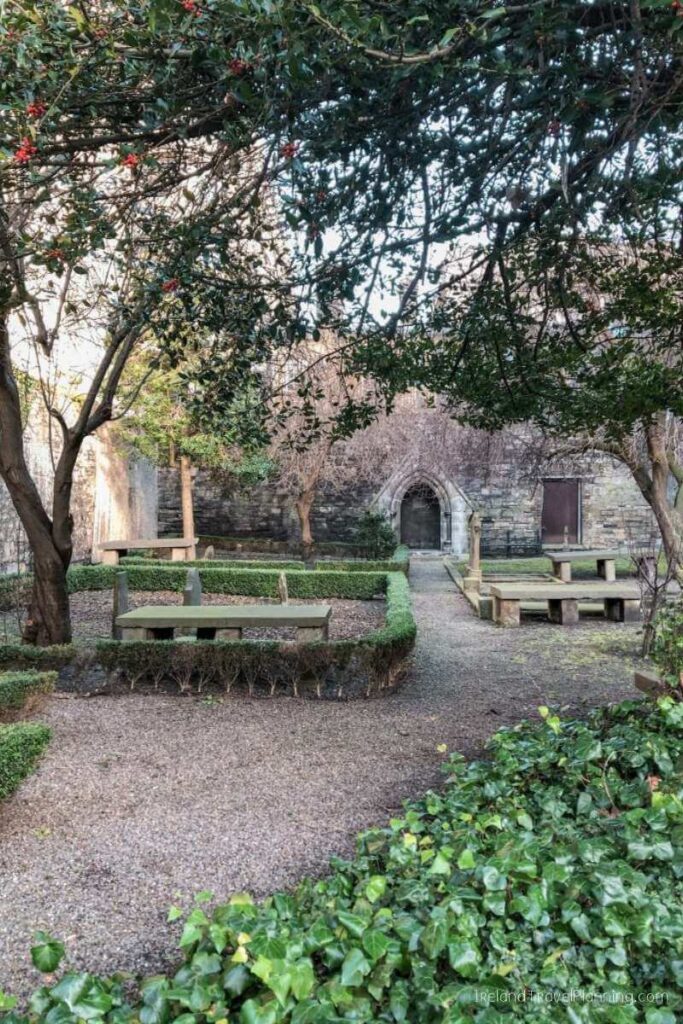 Hidden gem in Dublin: St. Mary's Abbey Chapter House ruins with stone benches and lush greenery in a peaceful setting.