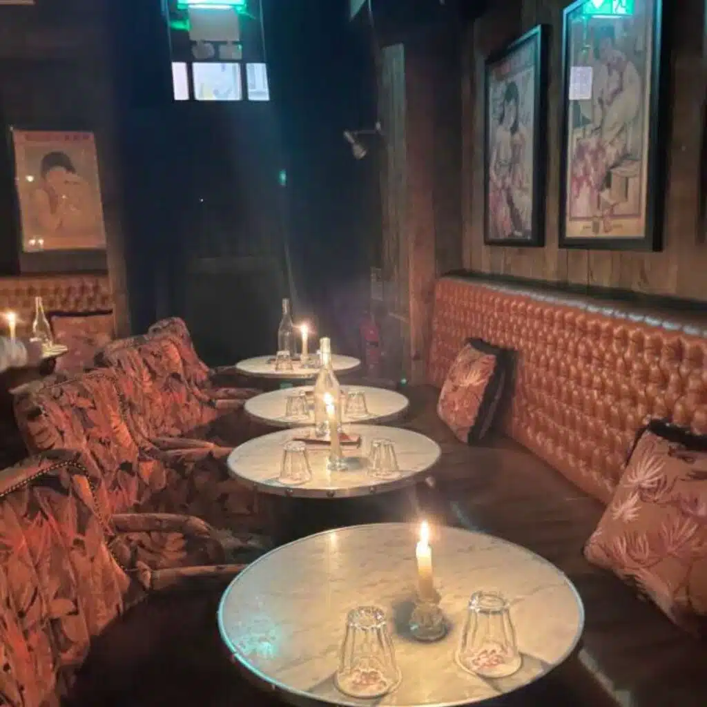 Cozy Dublin hidden gem: Candlelit tables and vintage decor in a dimly lit bar.