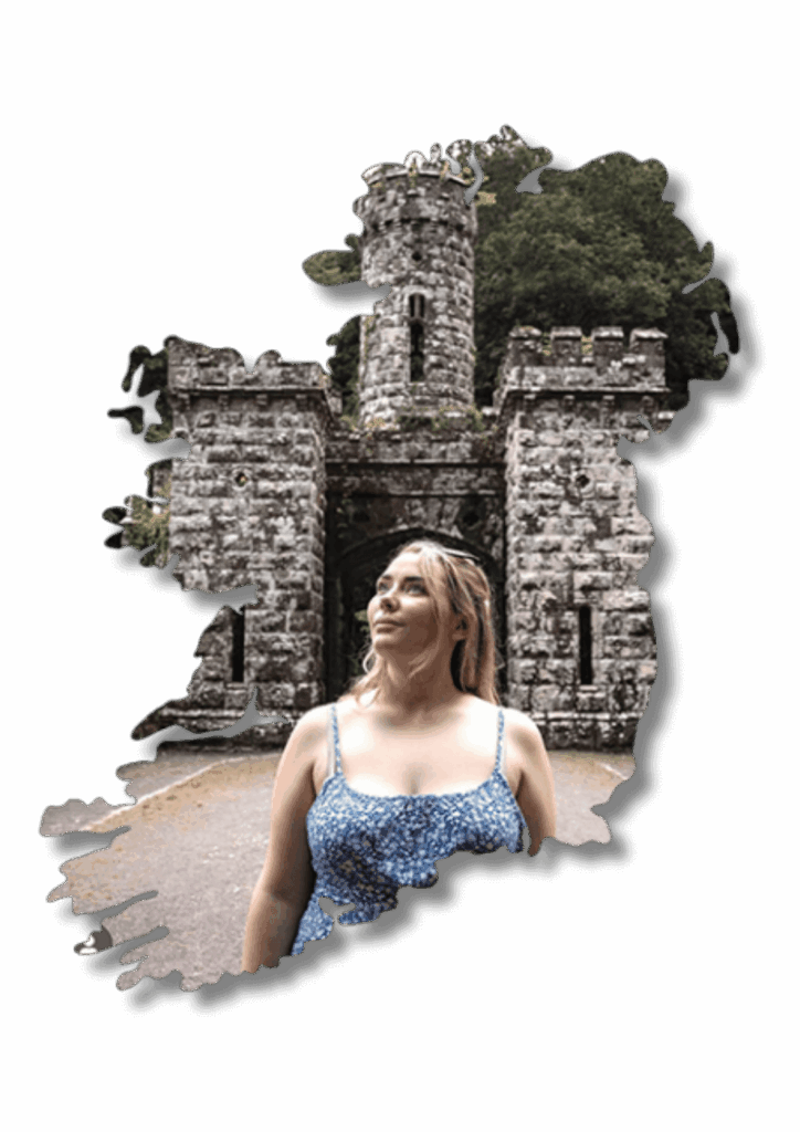 Woman in Ireland at a stone castle gate, travel planning by Laura Grace.