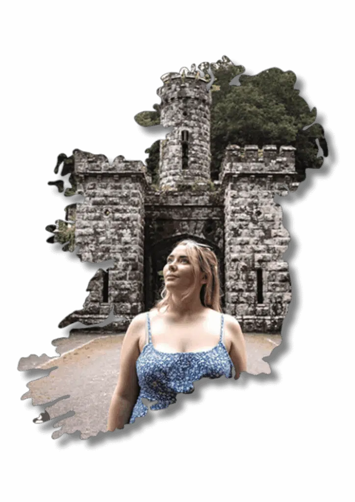 Woman in Ireland at a stone castle gate, travel planning by Laura Grace.
