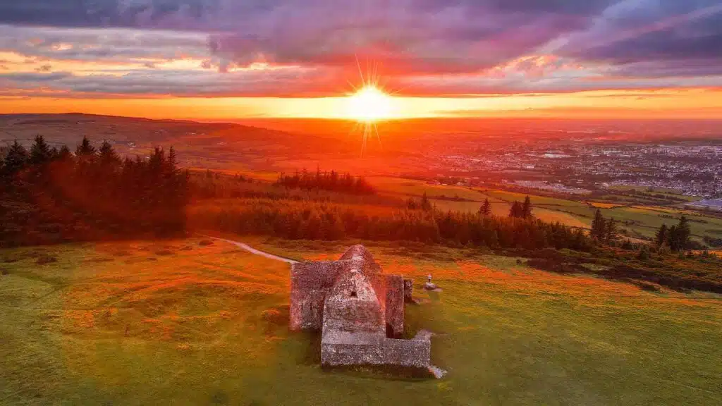 Sunset over the Hellfire Club ruins, a breathtaking spot to watch the sunset in Dublin, Ireland.