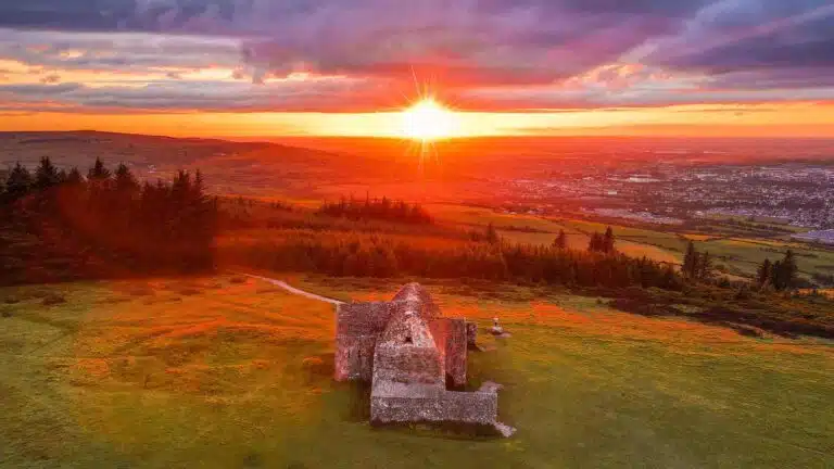 Sunset over the Hellfire Club ruins, a breathtaking spot to watch the sunset in Dublin, Ireland.
