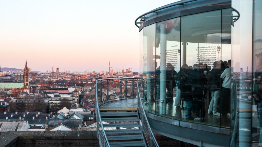 Dublin view from Guinness Storehouse, featuring city skyline and glass observation deck.