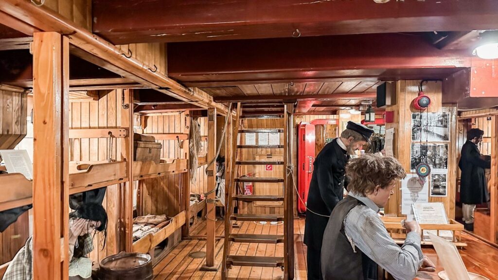 Dublin Pass interior tour showcasing wooden bunks and guide with map