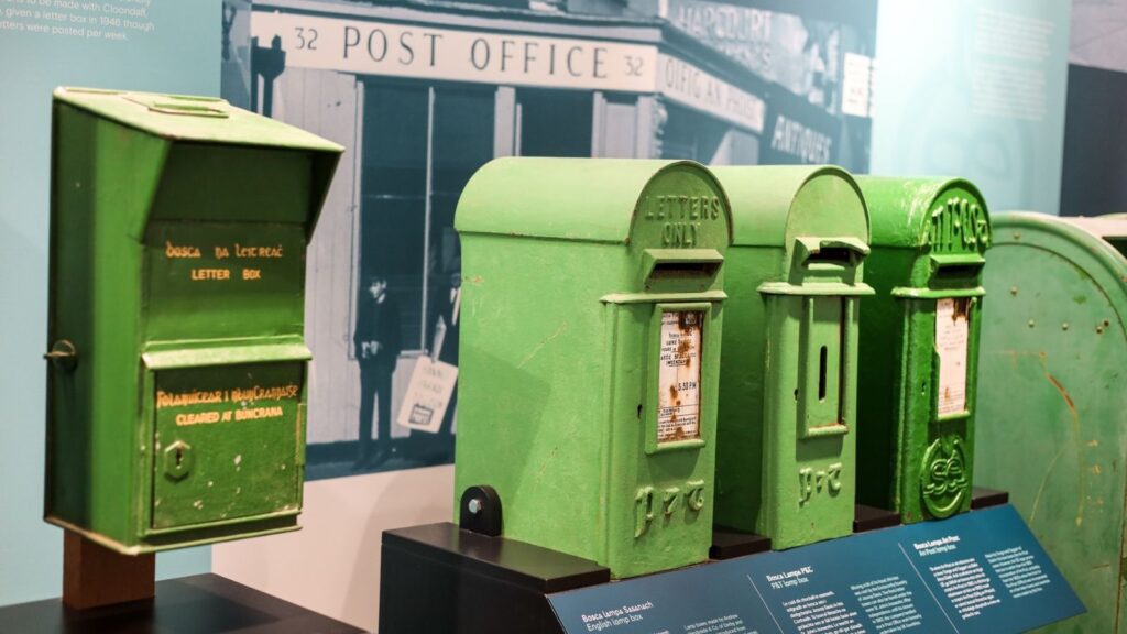 Collection of vintage green Irish post boxes, "LETTER BOX" text visible.