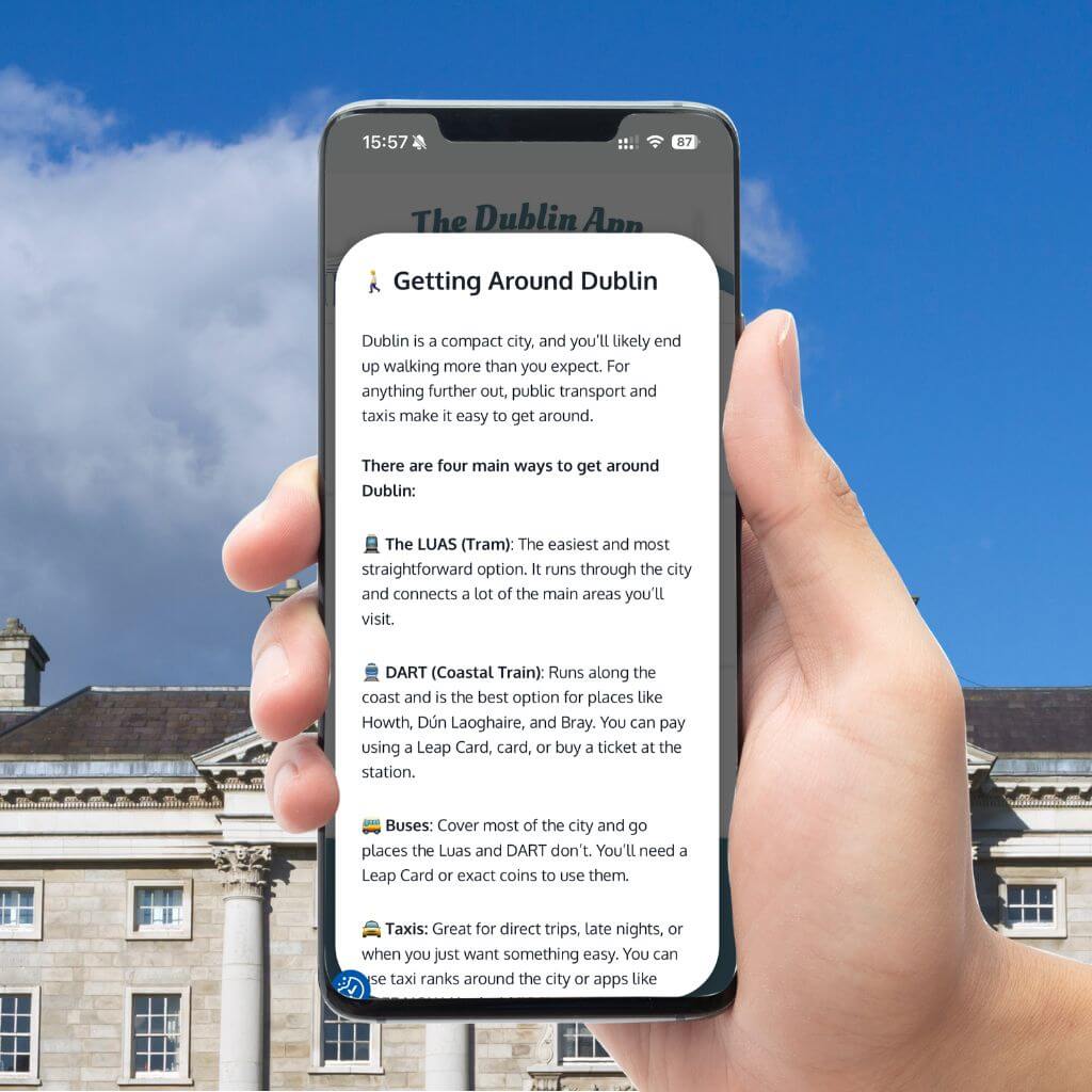 Hand holding phone displaying Dublin App info on getting around Dublin, including Luas, DART, and taxis.