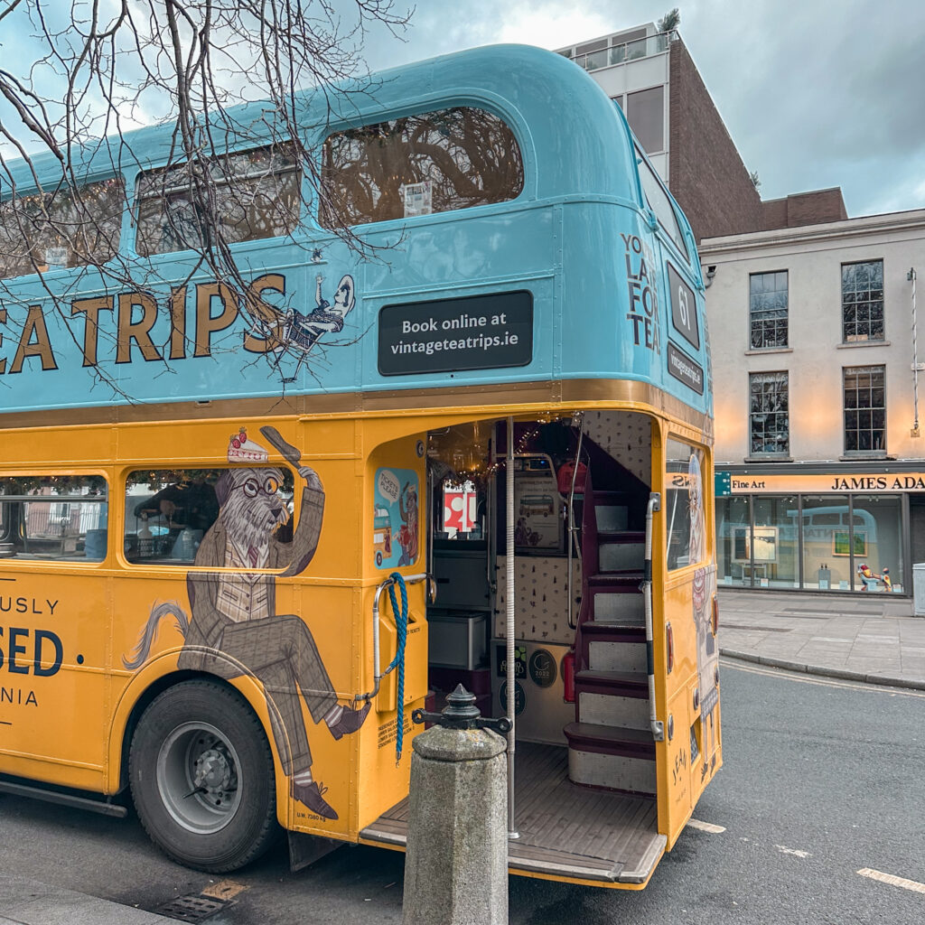 Vintage Tea Trips bus in Dublin, with stairs leading up to the second level.