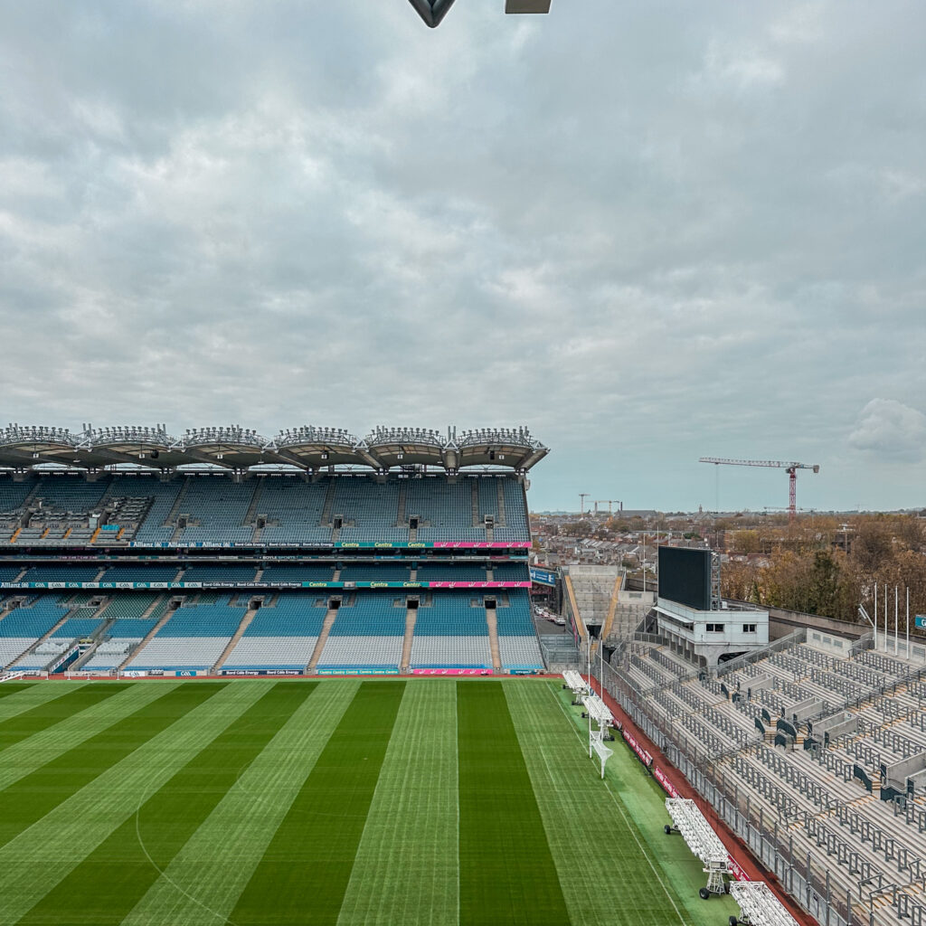 Croke Park stadium view, Dublin, with green pitch and seating under a cloudy sky.