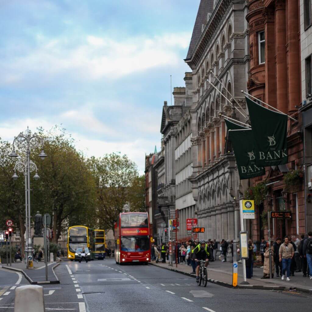 Dublin street scene with red double-decker bus and pedestrians.