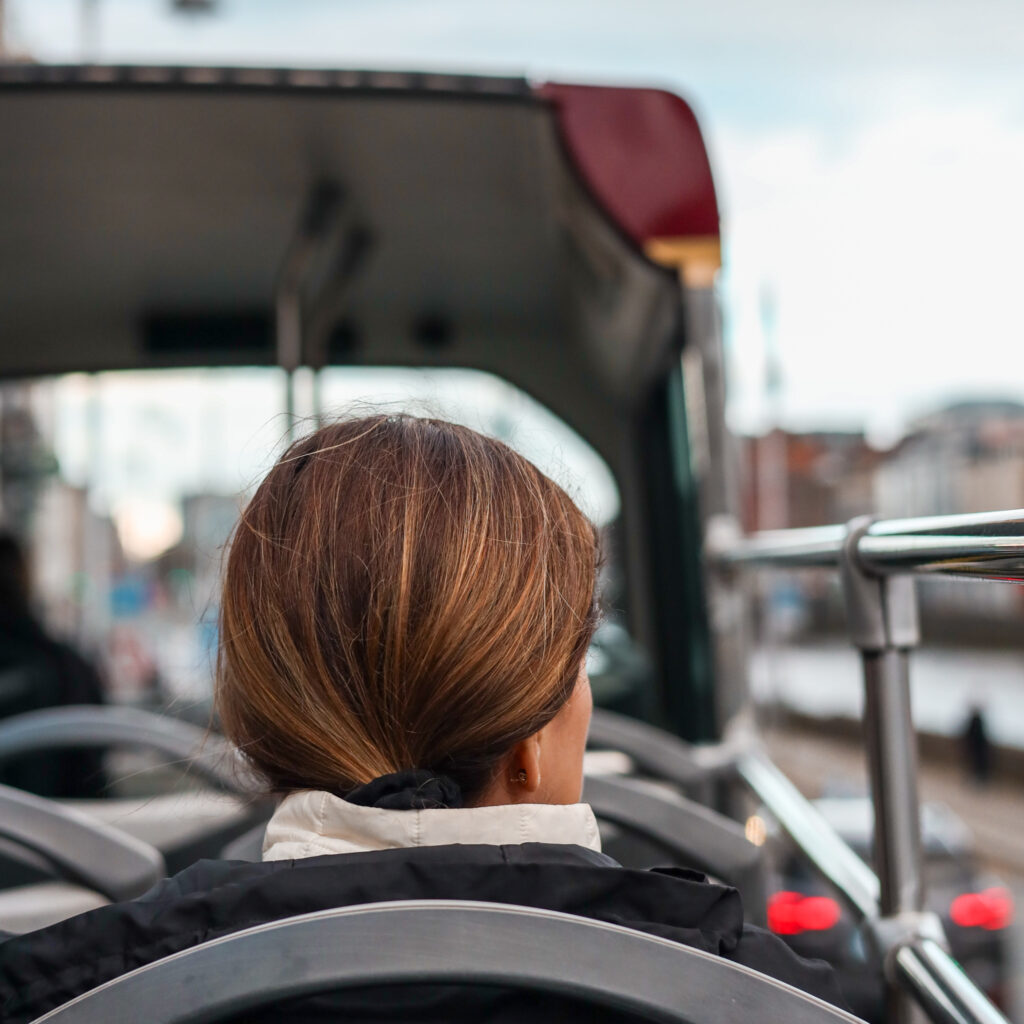 Woman on a Dublin tour bus, enjoying the sights.