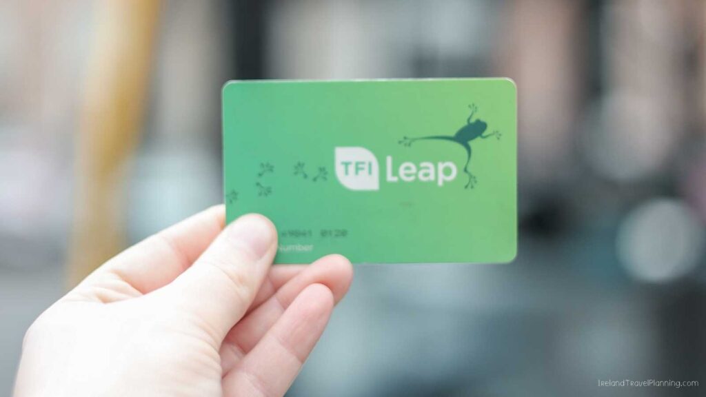 TFI Leap Card, a green public transport card with a frog logo, held by a hand.