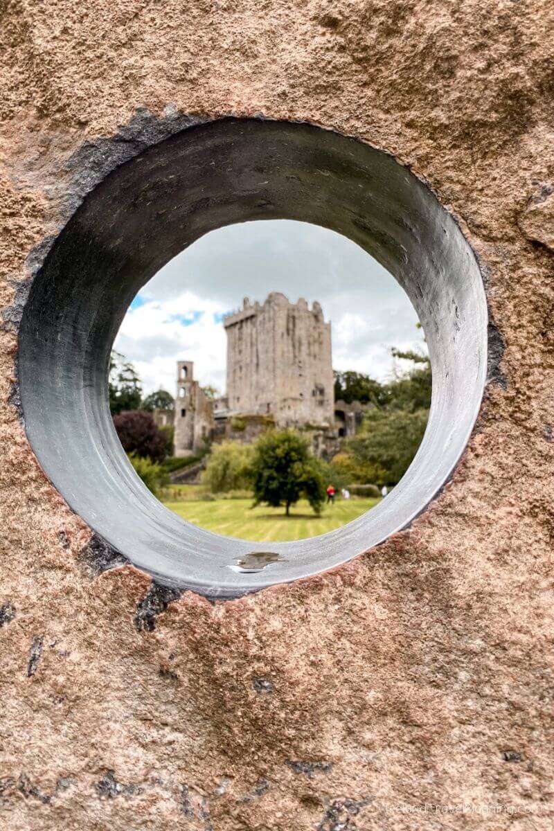 Blarney Castle viewed through a stone hole, a top Cork attraction.