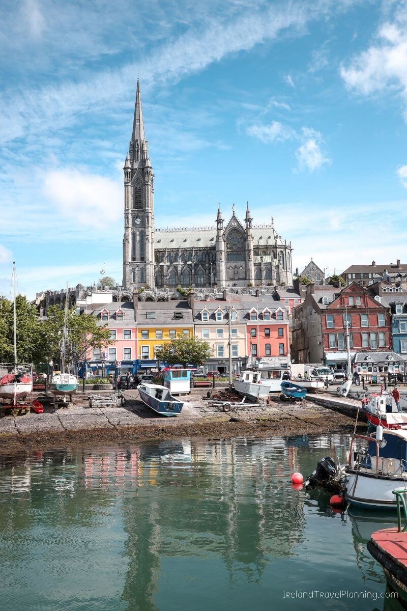 Cobh, Ireland waterfront with colorful buildings and St. Colman's Cathedral