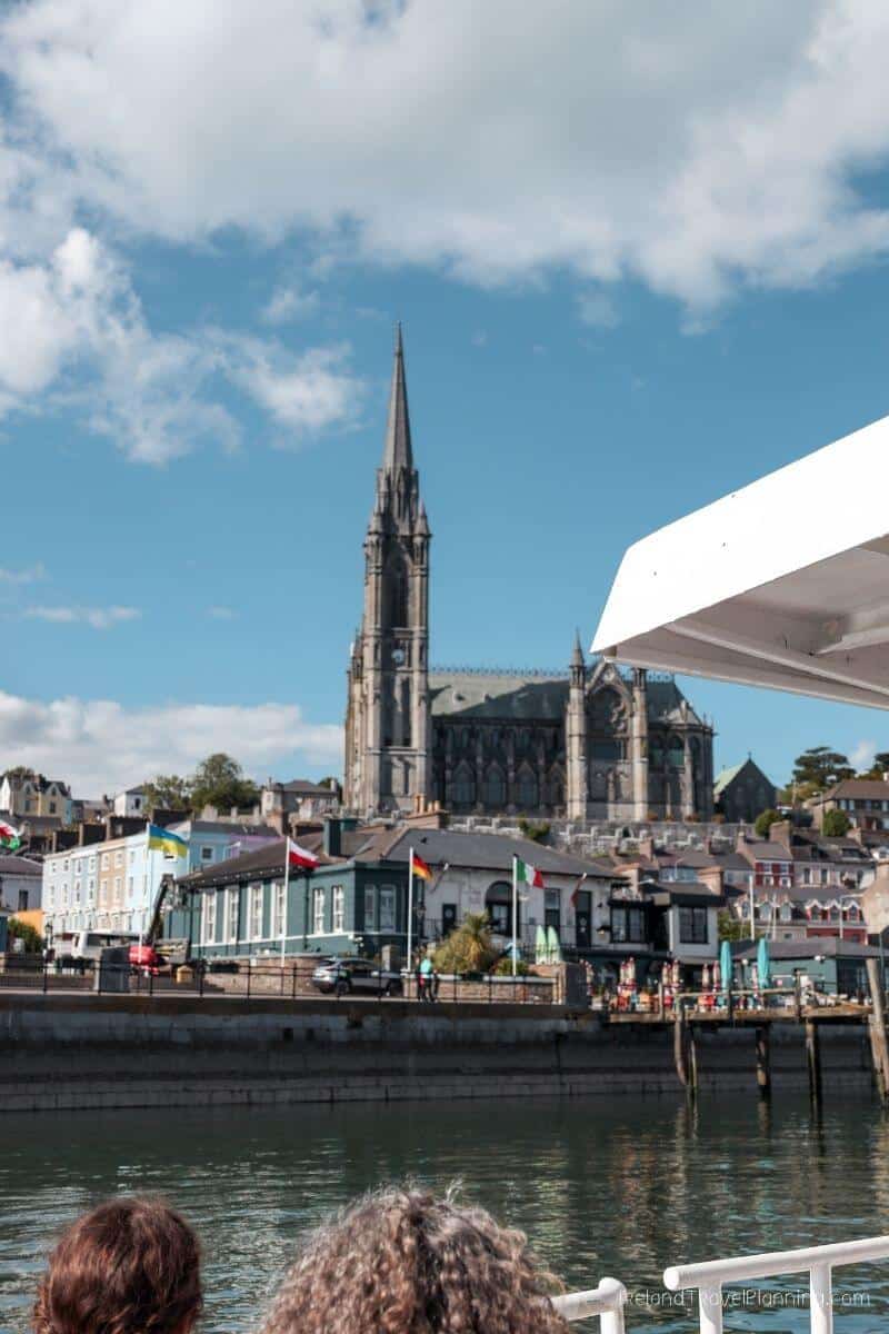 View from a boat of Cork City, featuring colorful buildings and St. Mary's Cathedral