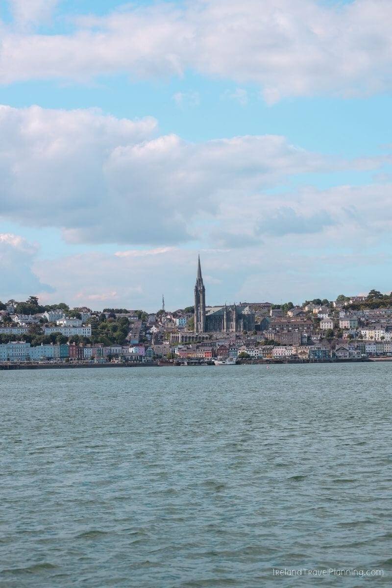 Panoramic Cork City skyline with St Mary's Cathedral, colorful buildings, and a waterfront