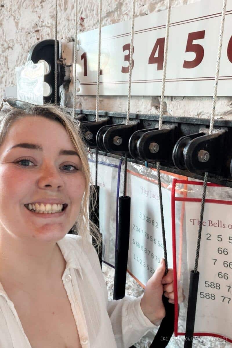 Woman smiling beside The Bells of Shandon in Cork City