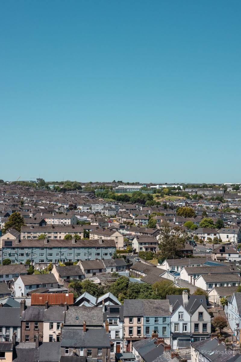 Aerial view of Cork City residential area with diverse colored houses under a clear sky