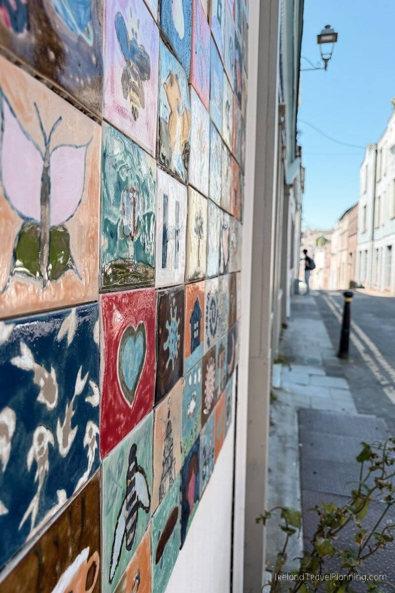 Colorful tile art on a building wall in Cork City, Ireland