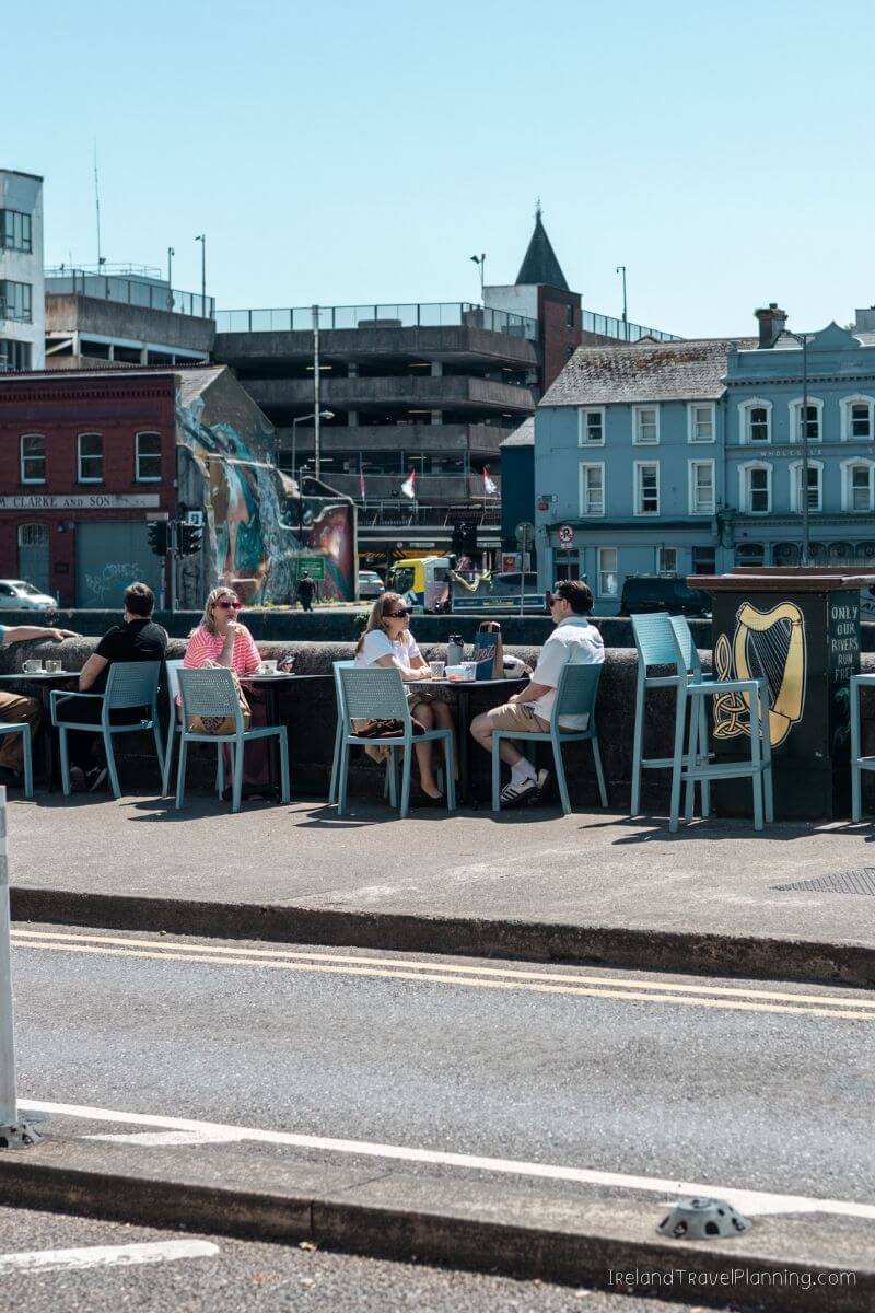 Group of people dining at a café on a street in Cork City